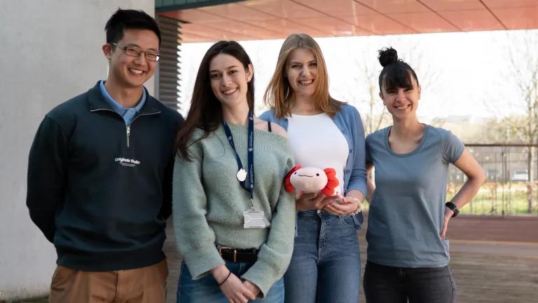 Rodrigo Albors lab group holding axolotl plushie