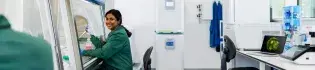 Research smiling at colleague in tissue culture lab