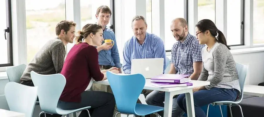 Group of researchers around a laptop