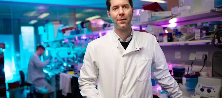 A man in a lab coat standing in a lab